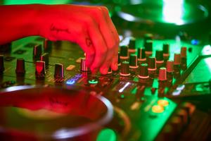 a person is playing a sound mixer in a mixing board at Universal Hotel Neptuno - Adults Only in Playa de Palma
