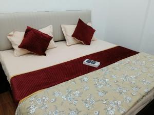 a bed with a cell phone sitting on top of it at galaxy hotel jobner in Jobner