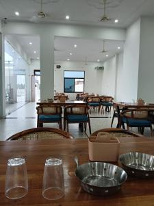 a dining room with wooden tables and chairs at galaxy hotel jobner in Jobner +24 photos