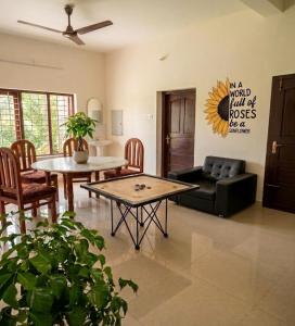 a living room with a couch and a table at Villa Mud Apple in Varkala