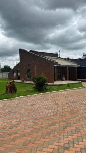 a brick building with a brick driveway in front of it at The Savannah Escape in Norton