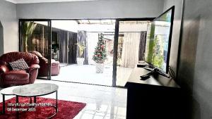 a living room with a television and a couch and a table at The Savannah Escape in Norton