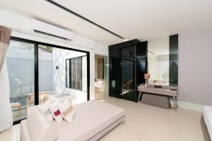 a living room with a white couch and a sink at Cae Villa Hua Hin in Hua Hin