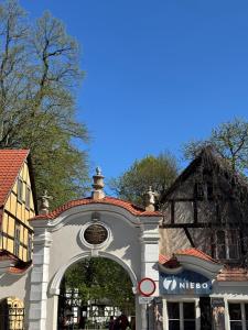a building with an archway in front of a building at Apartament przy Kościele in Świdnica