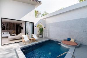 a swimming pool in the backyard of a house at Cae Villa Hua Hin in Hua Hin