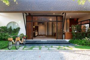 two bikes parked in front of a house at Cae Villa Hua Hin in Hua Hin