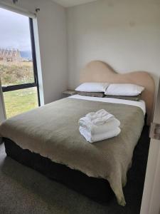 a bedroom with a bed with two towels on it at Twizel getaway in Twizel