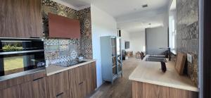 a kitchen with wooden cabinets and a counter top at Quinta Cuadrao in Cartavio