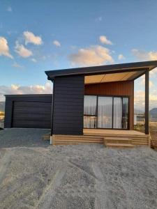 a small house on top of a field at Twizel getaway in Twizel