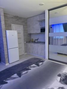 a kitchen with a white refrigerator in a room at Гагарина 119 in Dnipro
