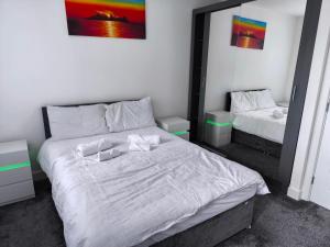a bedroom with two beds and a mirror at Teddy's in Immingham