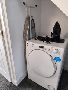 a washing machine in a room with a backpack on top at Teddy's in Immingham