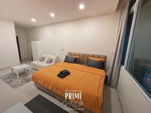 a bedroom with a bed with an orange blanket at Prime Silom in Bangkok