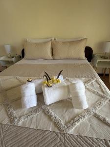 a bed with towels and flowers on top of it at Cabañas Anariki in Hanga Roa +15 photos
