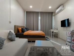 a living room with a bed and a couch at Prime Silom in Bangkok