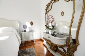 a bathroom with a large mirror and a sink at Appartamenti Il Sogno in Bellagio +52 photos
