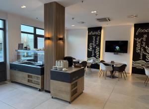 a restaurant with tables and chairs in a room at Tóth Wellness Apartman in Zalakaros