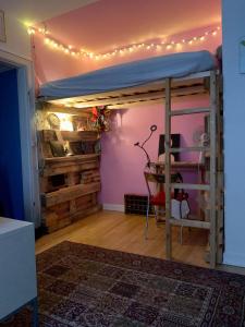a room with a bed with lights on it at Studio apartment by the metro in Copenhagen
