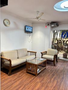 a living room with a couch and a coffee table at The Royal Samrat Newly renovated in Pune +45 photos