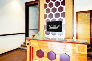 a front desk of a town house with a sign at OYO Townhouse Anantapur Near Srikantam Circle in Anantapur +36 photos