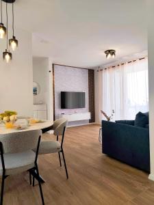 a living room with a table and a couch at Nashi Garden Apartment Split with City View & Parking in Solin