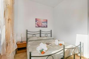 a bedroom with a bed with towels on it at Residence Argentiera in Miniera dellʼArgentiera +194 photos