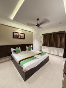 a bedroom with a large bed in a room at The Royal Samrat Newly renovated in Pune