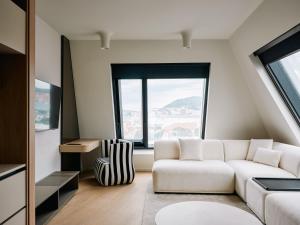 a living room with a white couch and a large window at Boutique Hotel Venturo, a Member of Design Hotels in Split +32 photos