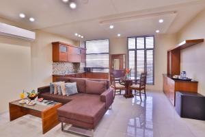 a living room with a couch and a table at Avari Xpress Faisalabad in Faisalabad