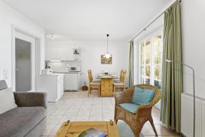 a living room with a couch and a table at Achtern Diek 13a - Wohnung 2 in Müggenburg