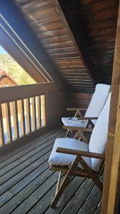 two lounge chairs on a deck with a roof at Memórias da Serra - Chalé Serra da Estrela Penhas da Saude in Penhas da Saúde +44 photos