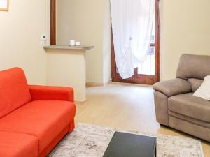a living room with a couch and a chair at Nel Centro Storico in Luserna San Giovanni