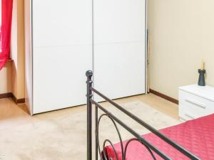 a bedroom with two large white closets at Nel Centro Storico in Luserna San Giovanni