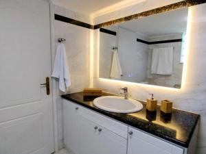 a bathroom with a sink and a mirror at Christina's Cottage in Agios Nikolaos +49 photos