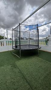 a swing sitting on top of a field of grass at Finca La Arboleda in Chipiona