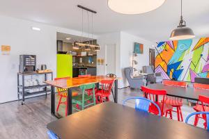 a dining room with tables and red chairs at HI Lisboa Oriente - Pousada de Juventude in Lisbon