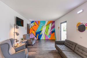 a living room with a painting on the wall at HI Lisboa Oriente - Pousada de Juventude in Lisbon