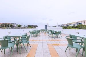 a row of tables and chairs on a roof at HI Lisboa Oriente - Pousada de Juventude in Lisbon