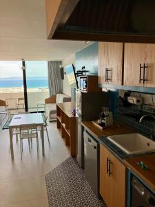 a kitchen with a table and a dining room at YaYaCaSa in Tangier