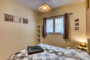 a bedroom with a bed and a window at La Colline des Pins in Aniane
