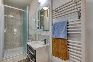 a bathroom with a sink and a shower at La Colline des Pins in Aniane +14 photos