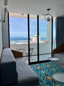 a room with a bed and a view of a city at YaYaCaSa in Tangier