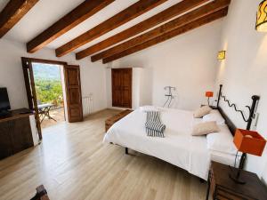 a bedroom with a large bed and a television at Hotel Moscari Nature & Wellness by CheelHotels in Moscari