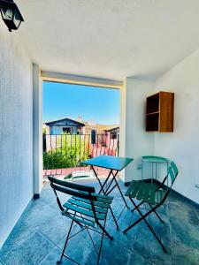 a table and chairs in a room with a view of a patio at Elyas Guest House in Villasimius