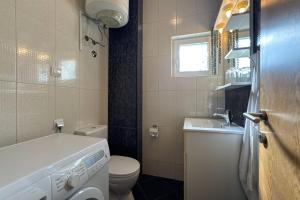 a small bathroom with a toilet and a sink at Ferienwohnung Penthouse Sunce in Bar