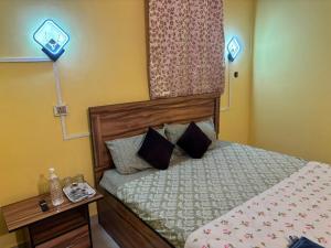 a small bedroom with a bed and a window at Mon Aashray Stay in Guwahati