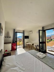a bedroom with a bed and a view of a kitchen at Elyas Guest House in Villasimius