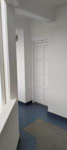 an empty room with a white door and a rug at On the Beach 20 in Swakopmund