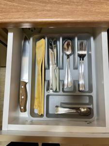 a tray with utensils in a drawer at Juliya Apartment in Kavadarci