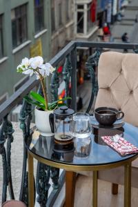 a table on a balcony with a coffee table with flowers on it at Vita Suites Karaköy in Istanbul +31 photos